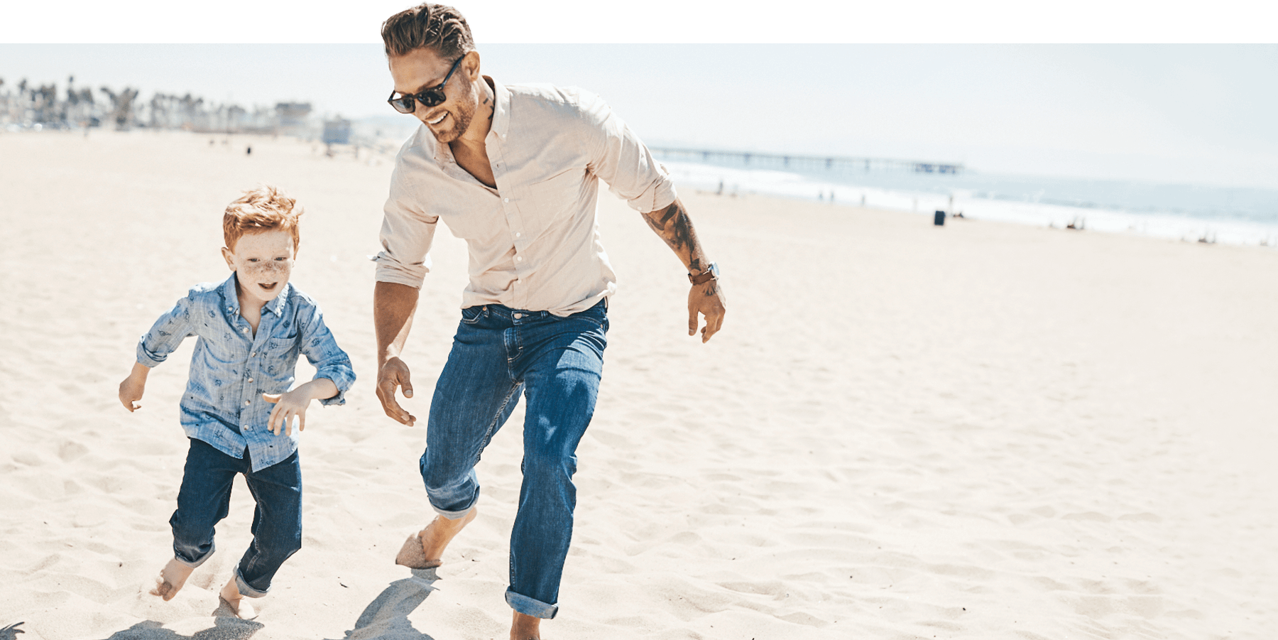 Man and his son playing on beach